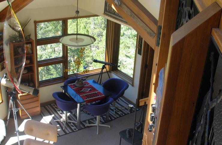 A game table is located in a sunny nook in the living room